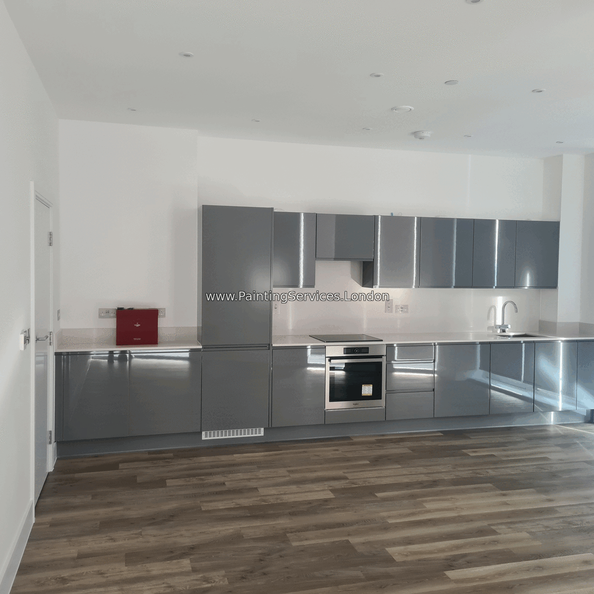 Professional painters in London working on an interior wall